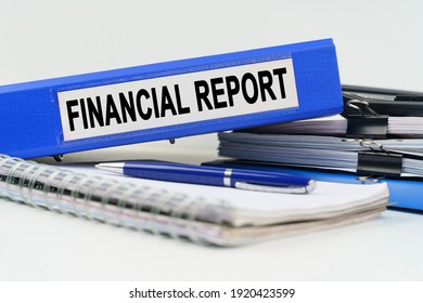 Business and finance concept. On the table are a notebook, a pen, documents and a folder with the inscription - FINANCIAL REPORT - Shutterstock ID 1920423599