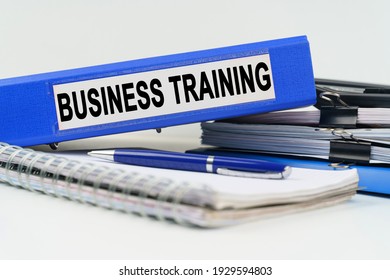 Business and finance concept. On the table are a notebook, a pen, documents and a folder with the inscription - BUSINESS TRAINING - Shutterstock ID 1929594803