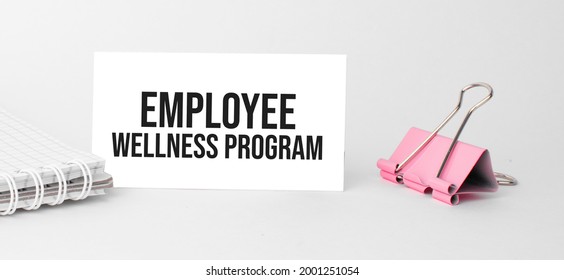 Business And Finance Concept. On The Table Is A Notebook, A Pen And A Business Card With The Inscription - Employee Wellness Program