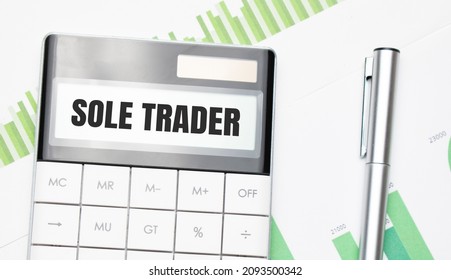 Business And Finance Concept. On The Table There Is A Pen And Calculator Which The Text Is Written SOLE TRADER