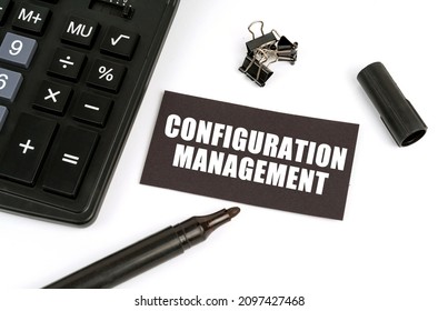 Business and finance concept. On a white table there is a calculator, a marker and a black plate with the inscription - Configuration Management - Shutterstock ID 2097427468