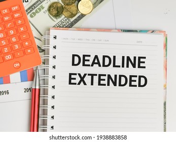 Business and finance concept. Phrase DEADLINE EXTENDED written on notebook with a pen,calculator,coins and fake money. - Shutterstock ID 1938883858