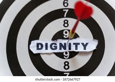 Business and finance concept. A piece of paper with the text is nailed to the target with a dart - DIGNITY - Shutterstock ID 1872667927