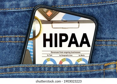 Business and finance concept. In a pocket of jeans there is a smartphone on the screen of which the text - HIPAA