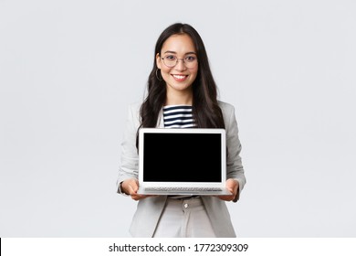 Business, Finance And Employment, Female Successful Entrepreneurs Concept. Professional Asian Businesswoman Having Meeting, Make Presentation On Laptop, Showing Screen With Pleased Smile