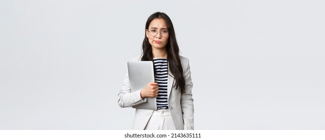 Business, Finance And Employment, Female Successful Entrepreneurs Concept. Sad And Doubtful Businesswoman Having Hesitations About Meeting, Smirk Displeased, Holding Laptop