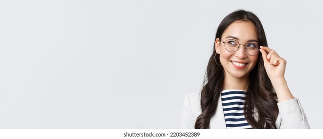 Business, finance and employment, female successful entrepreneurs concept. Close-up of dreamy and thoughtful smart asian woman, office worker in glasses, smiling and looking left