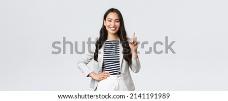 Business, finance and employment, female successful entrepreneurs concept. Good-looking confident female asian real estate broker being number one, offer good deal, showing finger and smiling