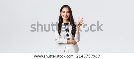 Business, finance and employment, female successful entrepreneurs concept. Successful female businesswoman, asian real estate broker pointing finger, showing number four and smiling