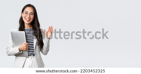 Business, finance and employment, female successful entrepreneurs concept. Friendly smiling office manager greeting new coworker. Businesswoman welcome clients with hand wave, hold laptop