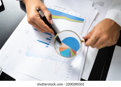 Business Finance Fraud. Corporate Investigation At Desk Using Magnifier Glass