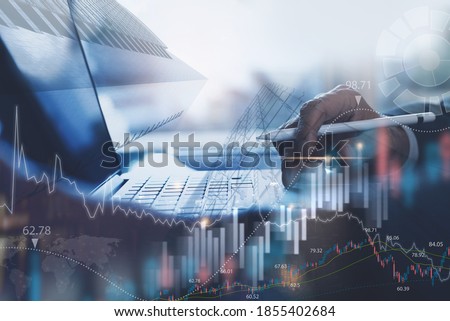 Business finance investment background, businessman or finance analyst working in office, monitoring with trading graph marketing report on virtual screen, business intelligence and technology concept