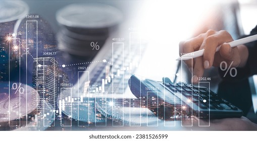 Business, finance and investment concept. Double exposure of business man using calculator, coins and the city with financial graph growth chart, stock market analysis, financial report
