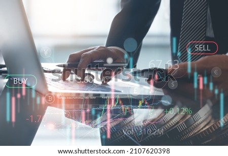 Business, finance and investment, forex trading, currency exchange, economic growth, stock market analysis concept. Double exposure of businessman using laptop and coins with financial graph chart