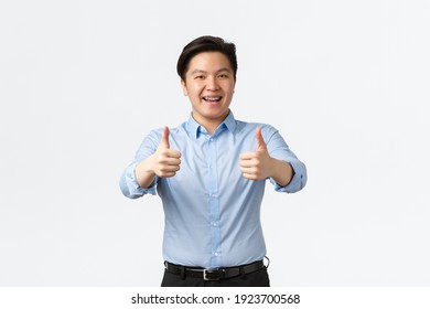 Business, Finance And People Concept. Enthusiastic Handsome Asian Male Office Worker, Employee With Teeth Braces, Showing Thumbs-up In Approval, Recommend Company, Guarantee Quality