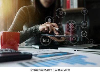 Business finance and business people use smartphones with laptops at the office. - Shutterstock ID 1386272840