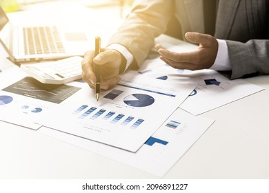 Business Finance Person Is Reviewing A Company's Financial Documents Prepared By The Finance Department For A Meeting With Business Partners. Concept Of Validating The Accuracy Of Financial Numbers.