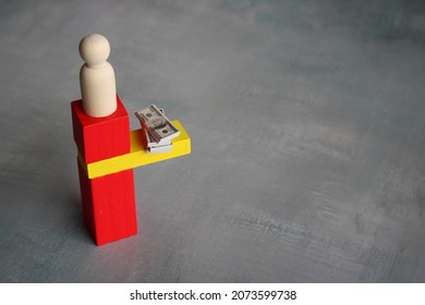 Business, Finance And Risk Concept. Stack Of Money On The Edge Of Wooden Tile. Copy Space For Text