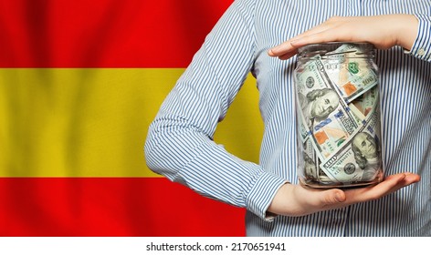 Business, Finance, Saving, Banking And Currency Exchange In Spain Concept. Hands Holding Us Dollar Money Jar