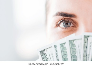 Business, Finance, Saving, Banking And People Concept - Close Up Of Woman Hiding Her Face Behind Us Dollar Money Fan