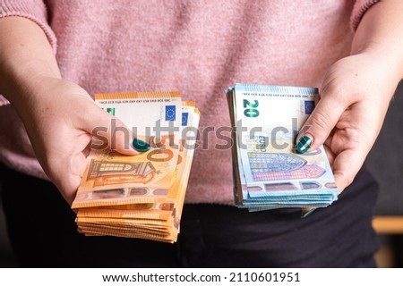 business, finance, saving, banking and people concept - closeup of woman hands counting euro money