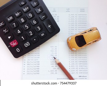 Business, Finance, Saving Money, Banking Or Car Loan Concept : Miniature Car Model, Calculator, And Saving Account Book Or Financial Statement On Office Desk Table