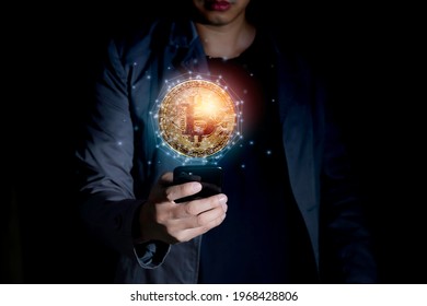 Business and Finance, Savings, Investing with Digital Assets, Future finance, blockchain. Businessman holding smartpone for golden cryptocurrency coins network concept
