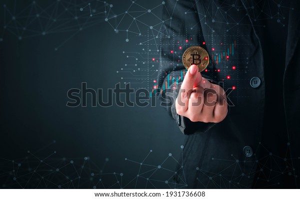 Business and Finance, Savings, Investing with\
Digital Assets, Future finance, blockchain. Business man holding\
golden cryptocurrency coins bitcoin on financial growth chart\
background.