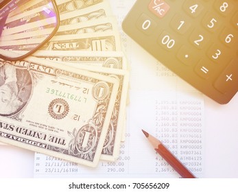 Business, finance, savings or loan concept : Money, calculator and pencil and eyeglasses on saving account passbook or financial statement - Shutterstock ID 705656209