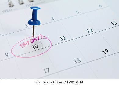 Business, finance, savings money, wages, payroll or accounting concept : Calendar with Blue thumbtack in word payday for remind