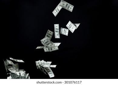 Business, Finance, Waste And Concept - Close Up Of Us Dollar Money Flying Over Black Background