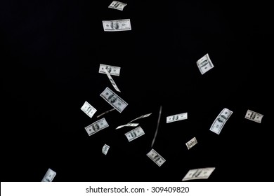 Business, Finance, Waste And Concept - Close Up Of Us Dollar Money Flying Over Black Background