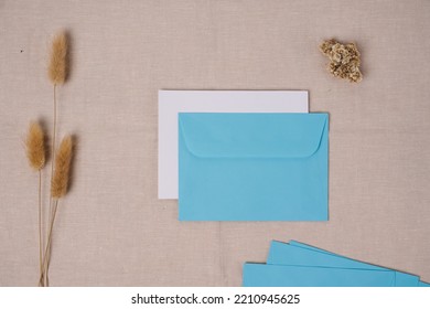 Business, Finance And Wedding Card Concept. Blank White Paper And Light Blue Envelope. Top View, Mockup.