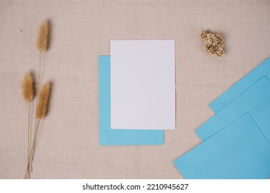 Business, Finance And Wedding Card Concept. Blank White Paper And Light Blue Envelope. Top View, Mockup.