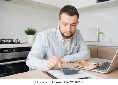 business, finances, accounting and people concept - man with money and calculator filling papers at home. savings, economy and home . - Shutterstock ID 2367218813