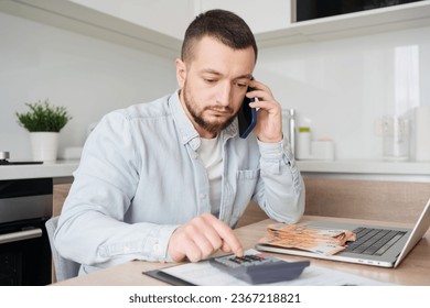 business, finances, accounting and people concept - man with money and calculator filling papers at home. savings, economy and home . - Shutterstock ID 2367218821