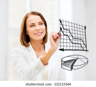 business, finances and economics - businesswoman drawing charts in the air - Powered by Shutterstock