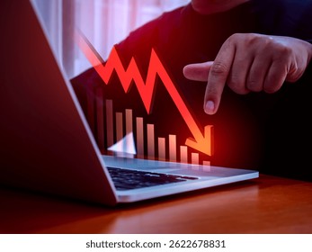 Business financial crisis, stock market down, bankruptcy concept. Economic downturn with 3d red falling arrow on lost investment graph, pointing by businessman finger on laptop computer on table.