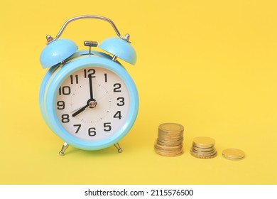 Business financial ideas concept with coins stack and alarmclock