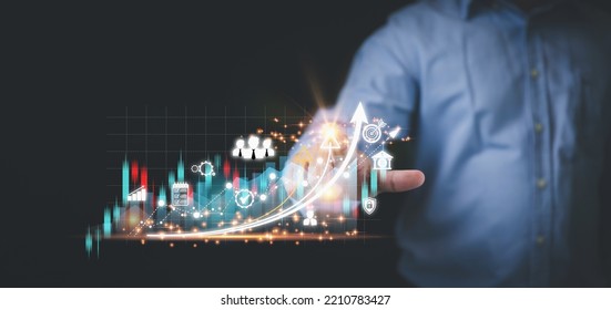 Business, financial, investment concept. Businessman touching the virtual screen on the growth graph of business with copy space. Planing strategy investment to stock trade for profit to the future. - Shutterstock ID 2210783427