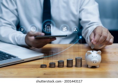 Business financial and planning for saving money concept. Businessman holding tablet with business analytics and financial and money stock coin, Growth graph.