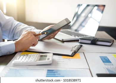 Business Financing Accounting Banking Concept, businessman using tablet and doing finances, calculate about cost to real estate investment and in other, tax system.
