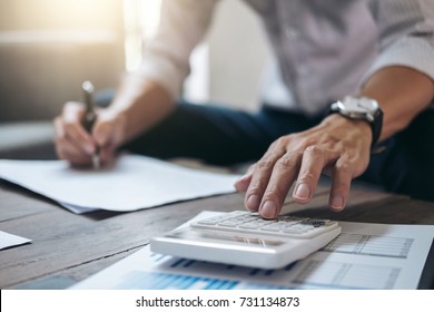 Business Financing Accounting Banking Concept, businessman doing finances and calculate about cost to real estate investment and in other, tax system.