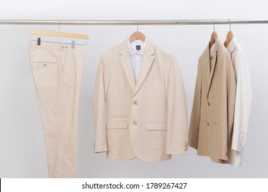 Business Formal Linen Suit With White Shirt And Khaki Pants On Hanger
