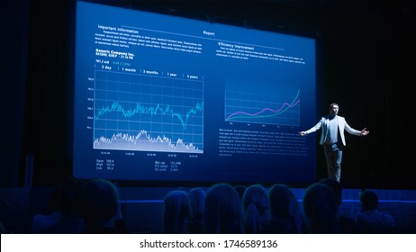 Business Forum Economics Conference Stage: Professional Speaker Concludes His Report With A Speech And Showing Infographics, Statistics On The Big Screen.