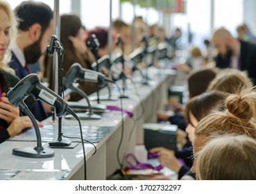 Business forum visitors register at check point - Powered by Shutterstock