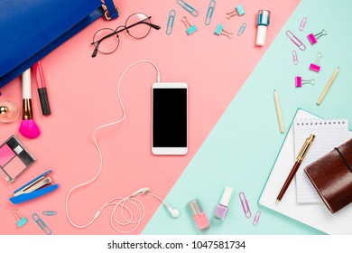 Business frame flatlay with woman's blue purse, glasses, smartphone with black copyspace, cosmetics and stationary supples. Pastel pink and mint background, mockup, women work bag contents