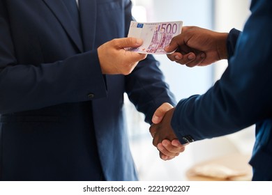Business fraud, corruption handshake and money deal, scam and criminal giving euro notes, bribery payment and illegal trading offer. Bad politician shaking hands for crime, cash and money laundering - Shutterstock ID 2221902207