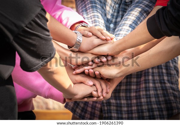 Business friend colleagues hand join together\
for successful business achievement. Young businesspeople putting\
their hands together. Stack of hands. join for success. teamwork\
concept.