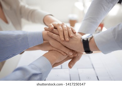business, gesture and teamwork concept - close up of businesspeople or architects stacking hands